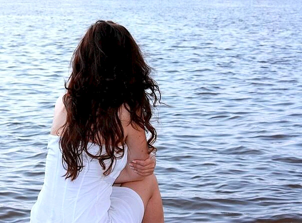 Mädchen mit schwarzen Haaren am Meer
