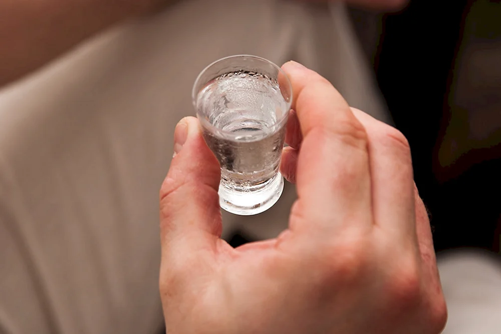 Wodka mit Kaviar in der Hand