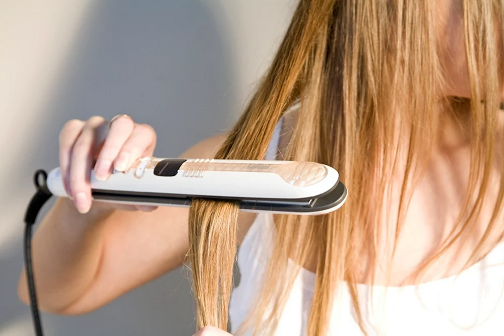 Mädchen glättet Haare
